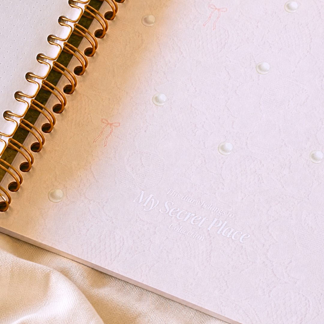 Pink inside cover and gold spiral binding of My Princess Diary